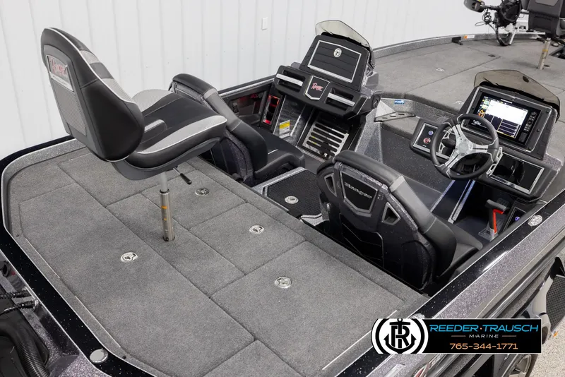 Slide: The Image of 2023 Ranger Z 521R boat interior with seating and control panel, Reeder-Trausch Marine branding. - 11