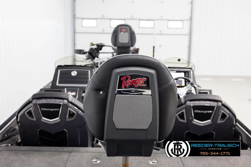 Slide: The Image of 2023 Ranger Z 521R boat interior with branded seat and dashboard in showroom. - 12