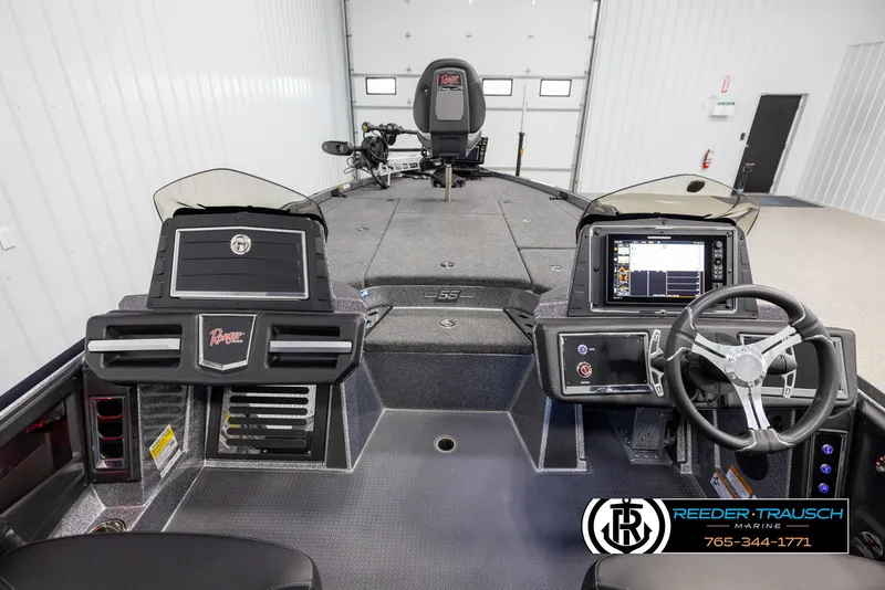 Slide: The Image of 2023 Ranger Z 521R boat interior with advanced dashboard and steering wheel in a showroom. - 13