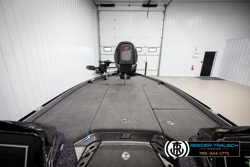 Slide: The Image of 2023 Ranger Z 521R boat interior in a garage, featuring spacious deck and modern equipment. - 14