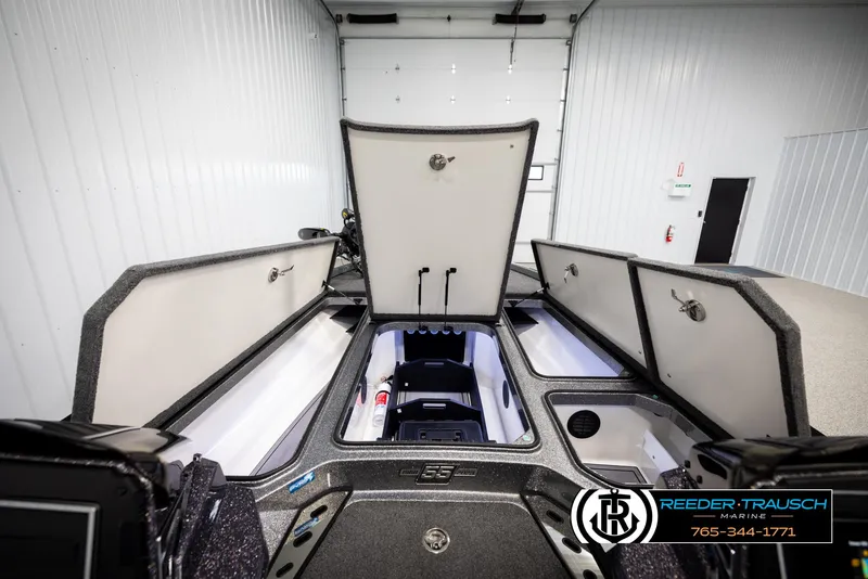 Slide: The Image of 2023 Ranger Z 521R boat storage compartments open in a showroom. - 15
