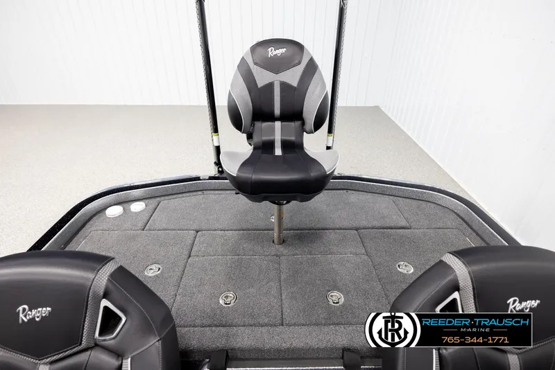 Slide: The Image of 2023 Ranger Z 521R boat interior with black seats and carpeted deck. - 18