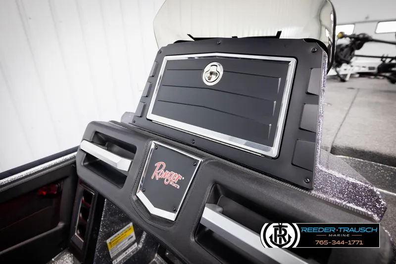Slide: The Image of 2023 Ranger Z 521R boat dashboard with storage compartment and logo. - 23