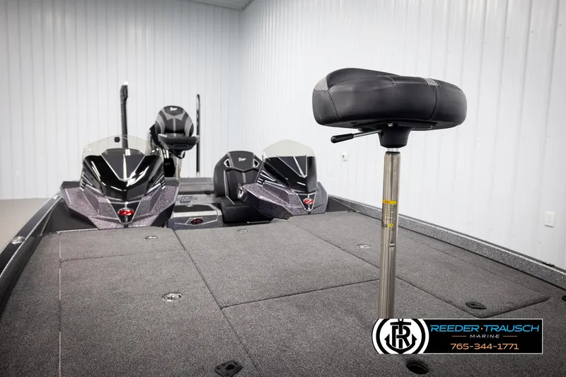 Slide: The Image of 2023 Ranger Z 521R boat interior with seating and console, displayed in a showroom. - 28
