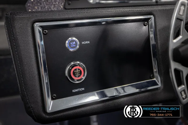 Slide: The Image of 2023 Ranger Z 521R dashboard with horn and engine start buttons, Reeder-Trausch Marine branding. - 32