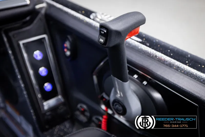 Slide: The Image of 2023 Ranger Z 521R boat control panel with throttle lever and illuminated buttons. - 39