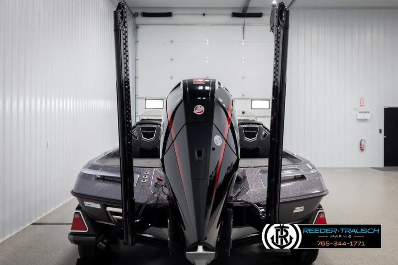 Slide: The Image of 2023 Ranger Z 521R boat in showroom, rear view with motor and power poles. - 6