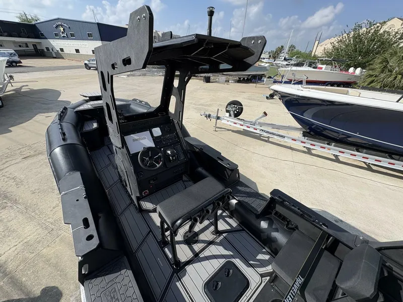 Slide: The Image of 2023 DGS 22 Monster boat with modern cockpit and seating, docked outdoors. - 11