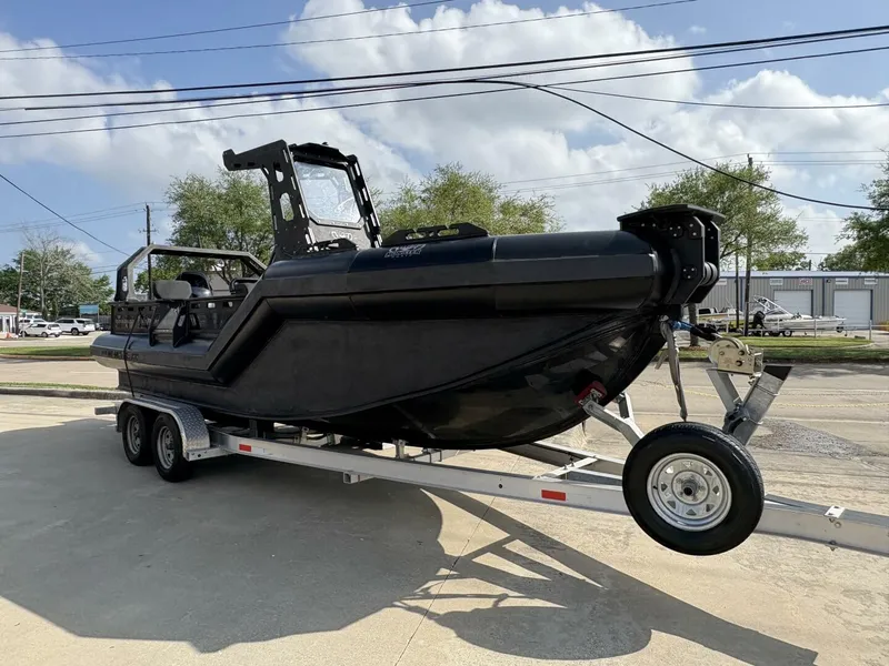 Slide: The Image of 2023 DGS 22 Monster boat on trailer, parked outdoors under a partly cloudy sky. - 12