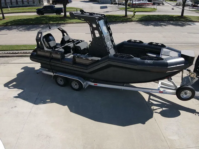 Slide: The Image of 2023 DGS 22 Monster boat on trailer, parked outdoors in a sunny area. - 3