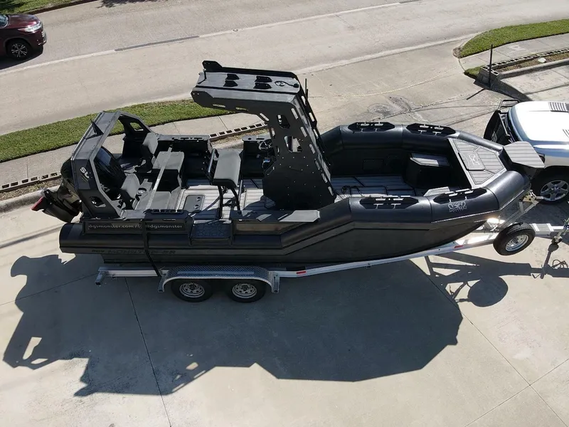 Slide: The Image of 2023 DGS 22 Monster boat on trailer, parked in driveway, aerial view. - 4