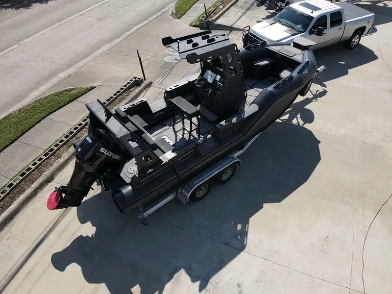 Slide: The Image of 2023 DGS 22 Monster boat on trailer, parked beside a white truck. - 5
