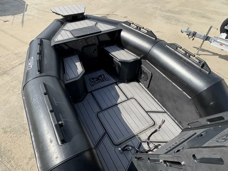 Slide: The Image of 2023 DGS 22 Monster boat interior with sleek black design and spacious seating. - 8