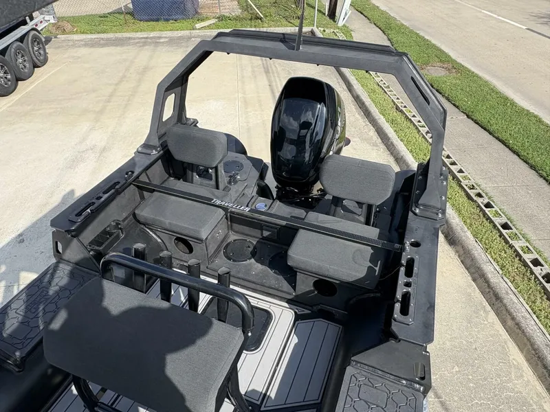 Slide: The Image of 2023 DGS 22 Monster boat interior with seating and motor, parked on concrete. - 9