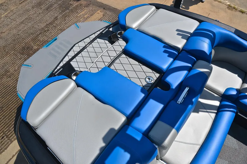 Slide: The Image of 2015 MasterCraft X20 boat interior with blue and gray seating, viewed from above. - 21
