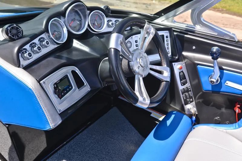 Slide: The Image of 2015 MasterCraft X20 boat dashboard with modern controls and blue accents. - 27