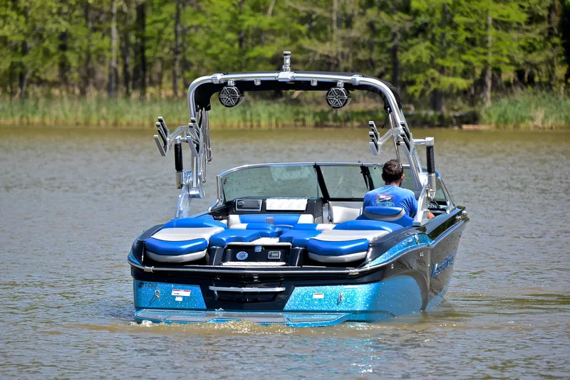 Slide: The Image of 2015 MasterCraft X20 boat on a lake with a person driving. - 8