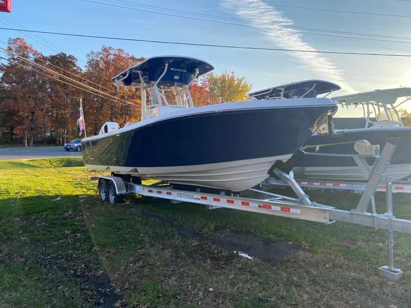 Slide: The Image of 2024 Sea Born LX24 Center Console boat on trailer, parked outdoors. - 0