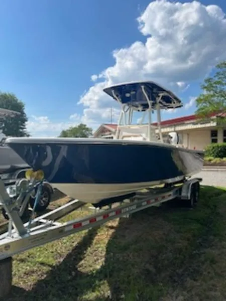 Slide: The Image of 2024 Sea Born LX24 Center Console boat on trailer under a blue sky. - 1