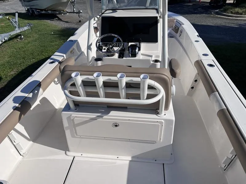 Slide: The Image of 2024 Sea Born LX24 Center Console boat interior with rod holders and steering console. - 10
