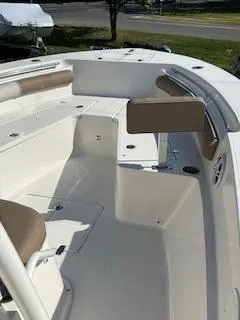 Slide: The Image of 2024 Sea Born LX24 Center Console boat interior with seating and storage compartments. - 11