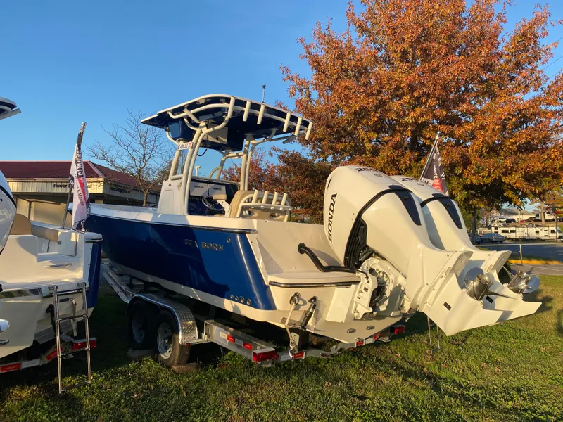 Slide: The Image of 2024 Sea Born LX24 Center Console boat with Honda engine, parked on grass. - 3
