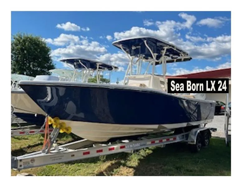 Slide: The Image of 2024 Sea Born LX24 Center Console boat on trailer under blue sky. - 4