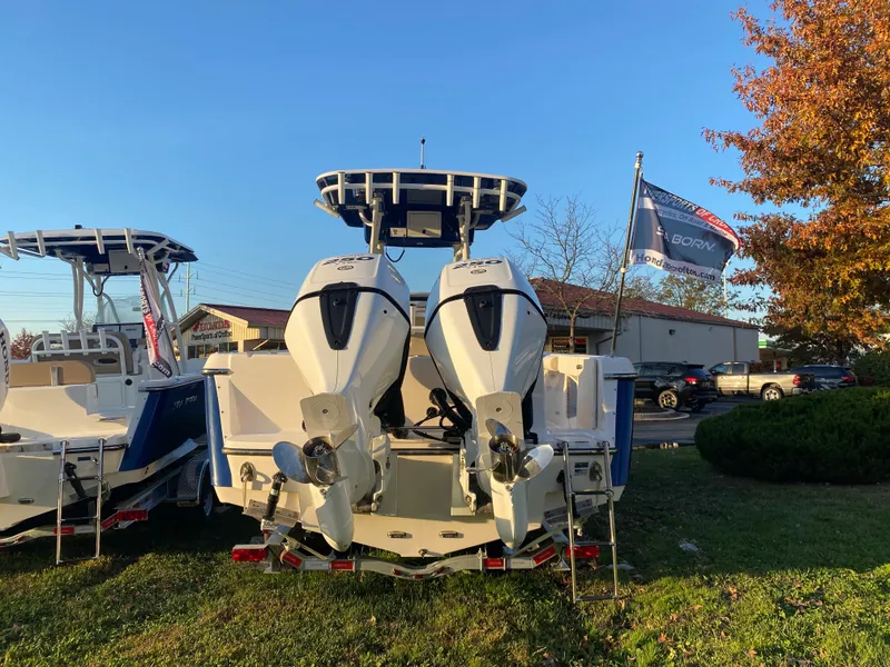 Slide: The Image of 2024 Sea Born LX24 Center Console boat with dual engines, displayed outdoors. - 5