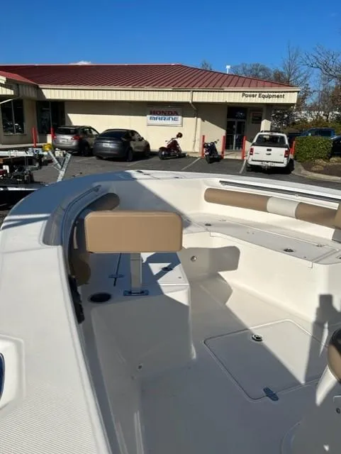 Slide: The Image of 2024 Sea Born LX24 Center Console boat at a dealership, showcasing spacious seating and modern design. - 6