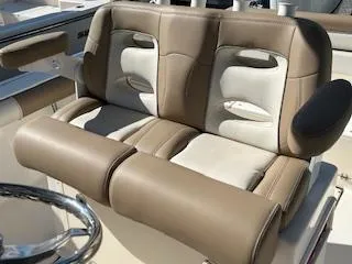 Slide: The Image of 2024 Sea Born LX24 Center Console boat seating, featuring tan and white cushioned seats. - 8