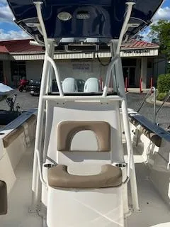 Slide: The Image of 2024 Sea Born LX24 Center Console boat with seating and T-top, docked outdoors. - 9