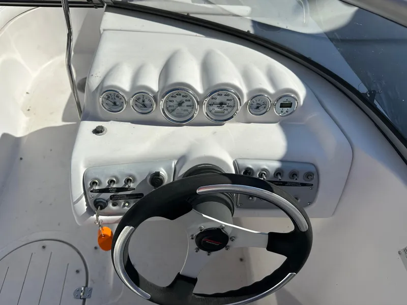 Slide: The Image of 2007 Smoker Craft Vectra 2042 OB boat dashboard with steering wheel and gauges. - 14