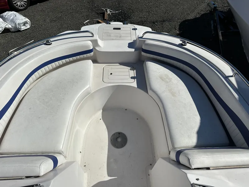 Slide: The Image of 2007 Smoker Craft Vectra 2042 OB boat interior with white seating and blue accents. - 17