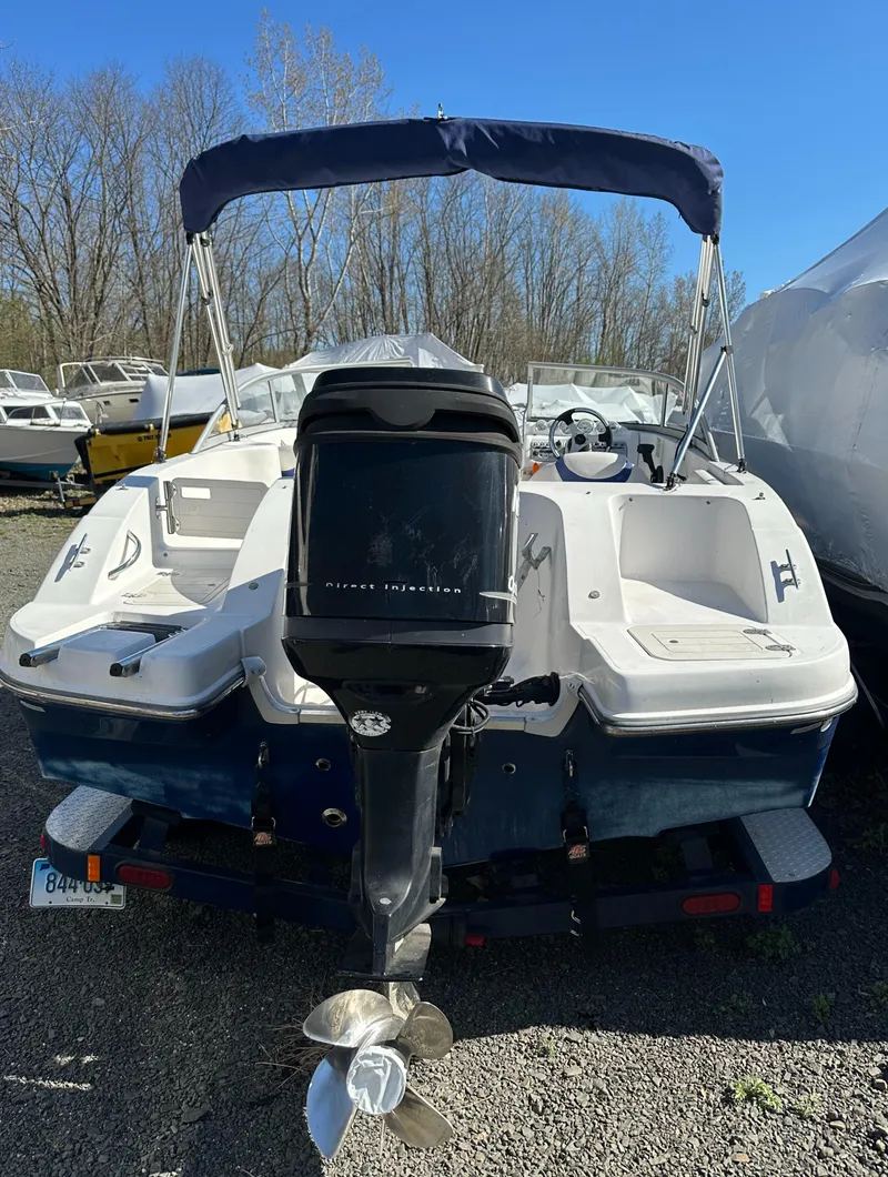 Slide: The Image of 2007 Smoker Craft Vectra 2042 OB boat with outboard motor and canopy, parked outdoors. - 23