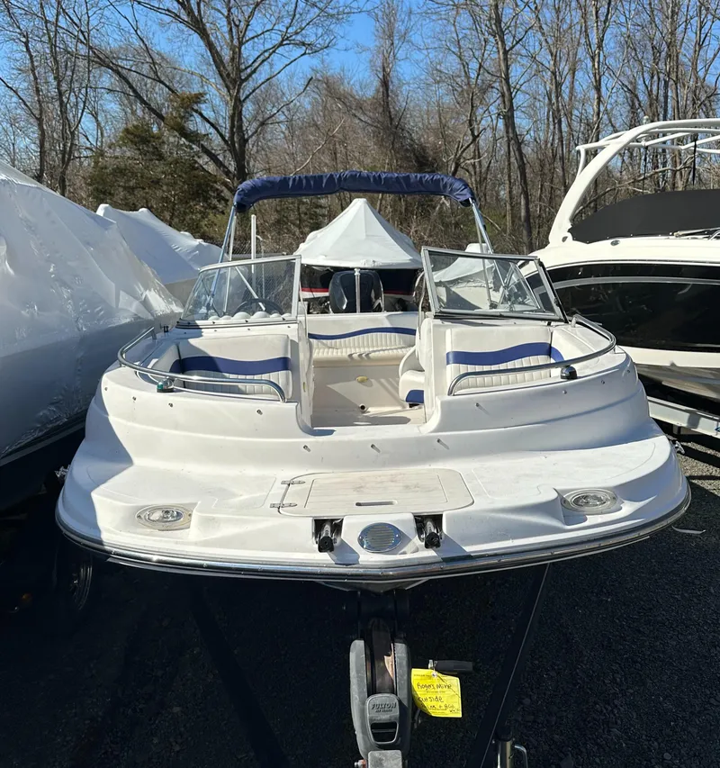 Slide: The Image of 2007 Smoker Craft Vectra 2042 OB boat, white with blue accents, parked outdoors. - 3