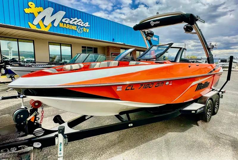 Slide: The Image of 2020 Malibu 21VLX boat in vibrant orange at Mattas Marine & RV dealership. - 1