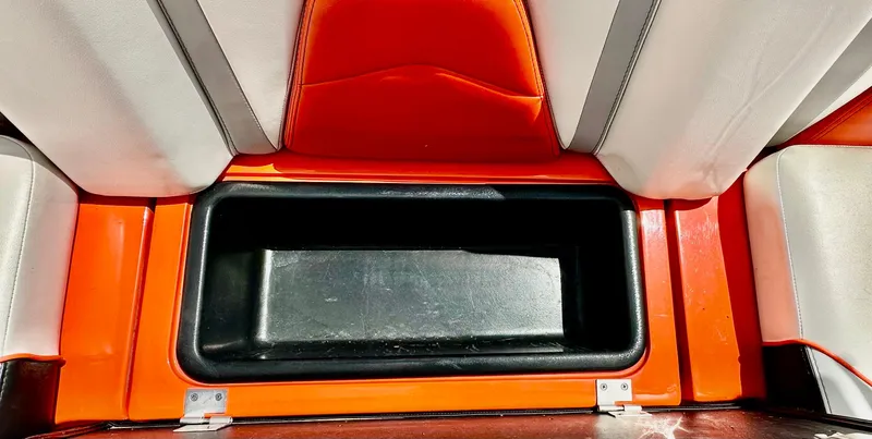 Slide: The Image of 2020 Malibu 21VLX boat storage compartment with orange and white interior. - 15