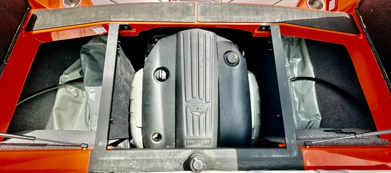 Slide: The Image of Engine compartment of a 2020 Malibu 21VLX boat, showcasing the engine and storage areas. - 16