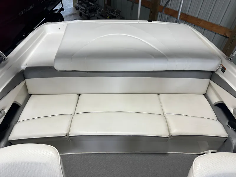 Slide: The Image of 2008 Bayliner 185 boat interior with white cushioned seating. - 15
