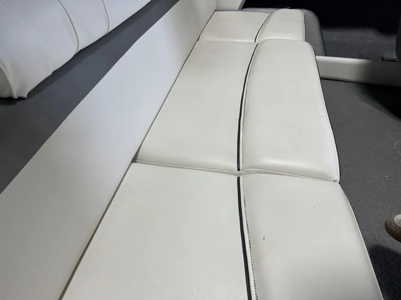 Slide: The Image of White leather seating in a 2008 Bayliner 185 boat interior. - 16