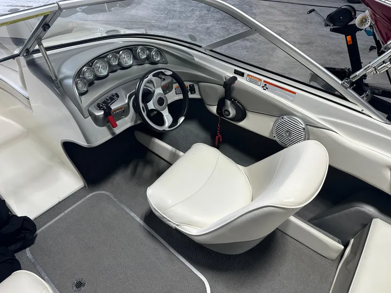 Slide: The Image of Interior of a 2008 Bayliner 185 boat showing steering wheel and dashboard controls. - 17