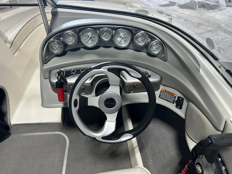 Slide: The Image of 2008 Bayliner 185 boat dashboard with steering wheel and gauges. - 18