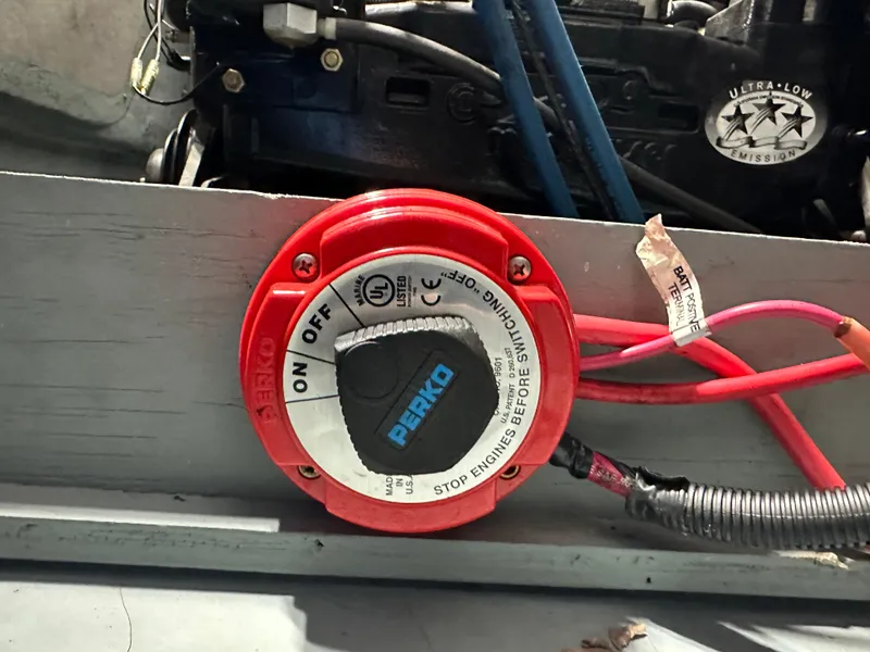 Slide: The Image of Red Perko battery switch in a 2008 Bayliner 185 boat engine compartment. - 22