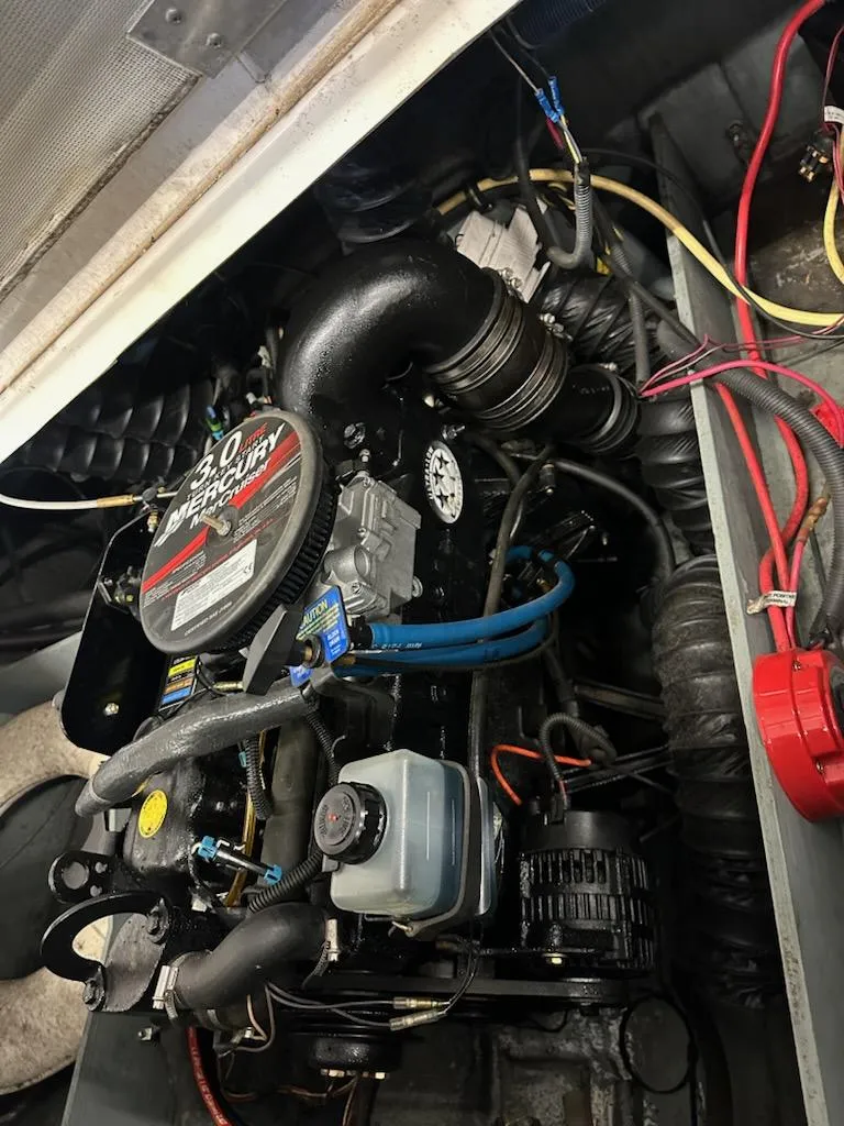 Slide: The Image of 2008 Bayliner 185 boat engine, featuring a 3.0L MerCruiser motor with visible wiring and components. - 9