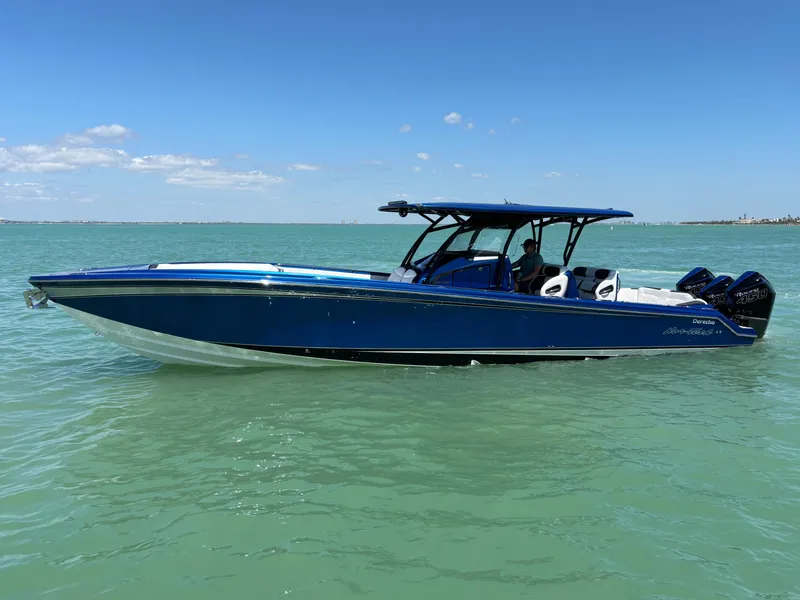 The Image of 2020 Nor-Tech 390 Sport boat on calm turquoise water under a clear blue sky. - 0