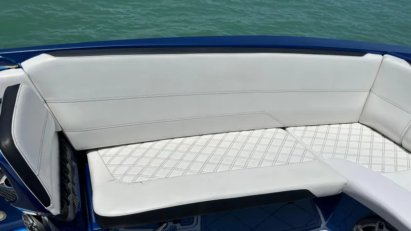 Slide: The Image of 2020 Nor-Tech 390 Sport boat with white cushioned seating and blue accents. - 16