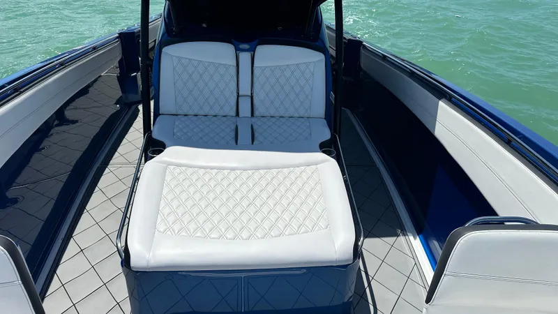 Slide: The Image of 2020 Nor-Tech 390 Sport boat interior with white diamond-stitched seating and blue accents. - 17
