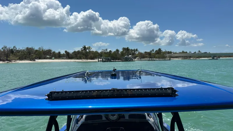 Slide: The Image of 2020 Nor-Tech 390 Sport boat cruising on turquoise water under a clear blue sky. - 19