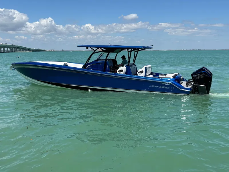 Slide: The Image of 2020 Nor-Tech 390 Sport boat in blue on calm sea under clear sky. - 2
