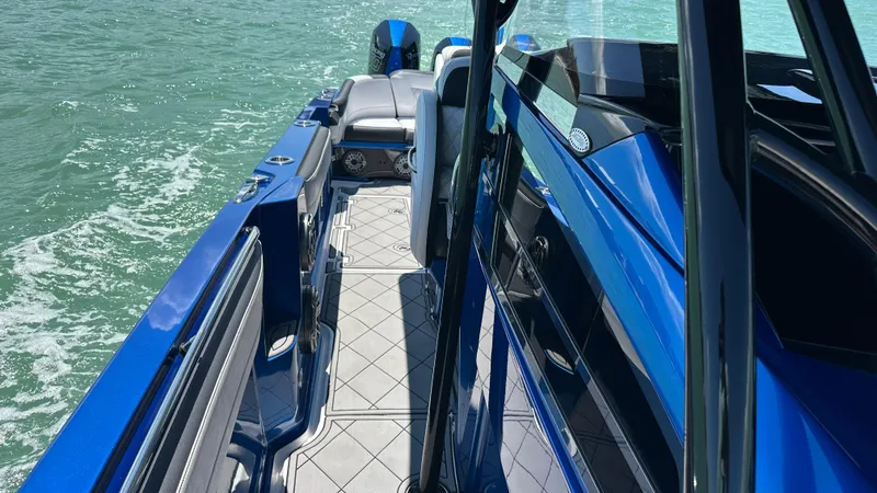 Slide: The Image of 2020 Nor-Tech 390 Sport boat, sleek blue design, cruising on open water. - 21
